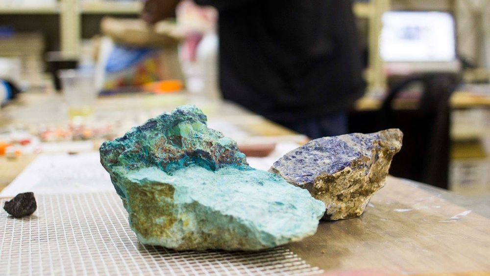 Raw turquoise and azurite mineral pieces on a studio table